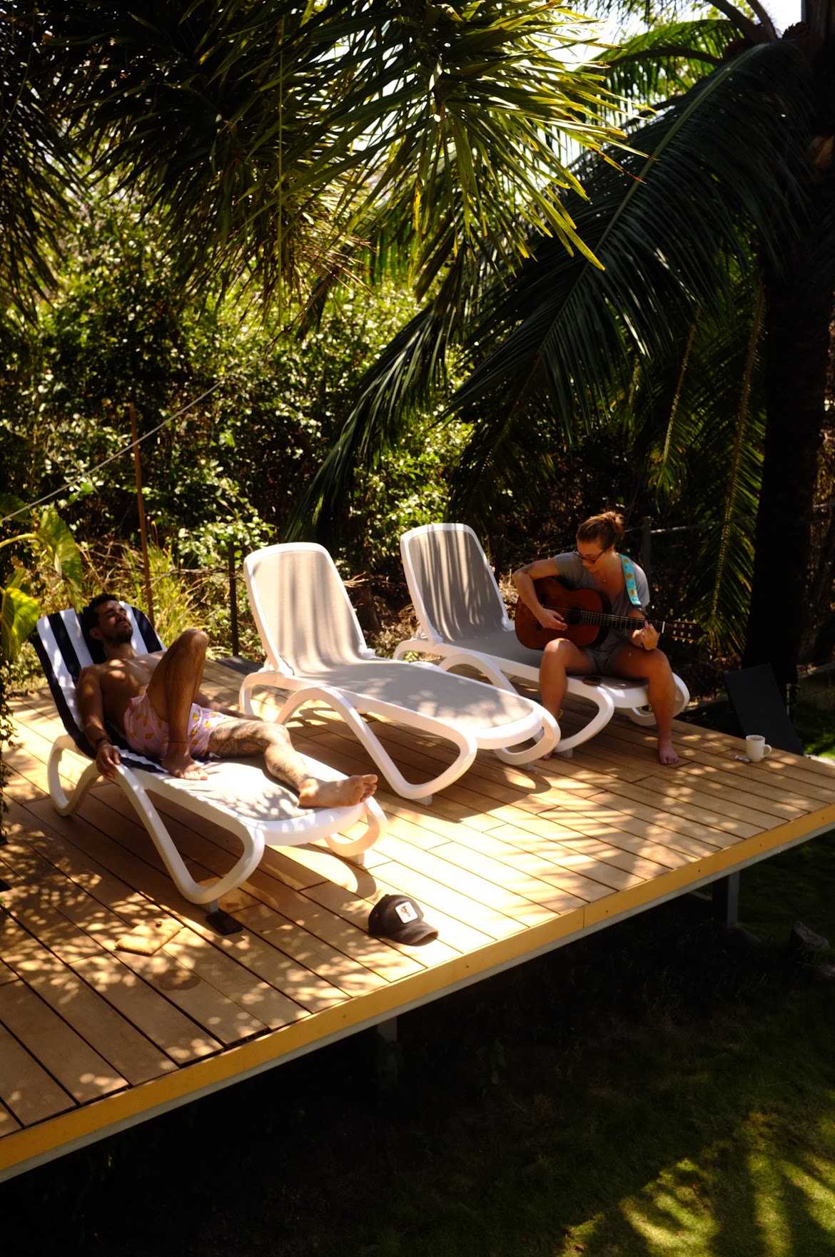 Relaxing on deck chairs with guitar
